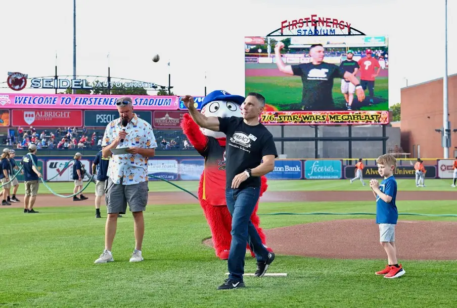 Jon Fine mid-motion throwing a baseball from the mound